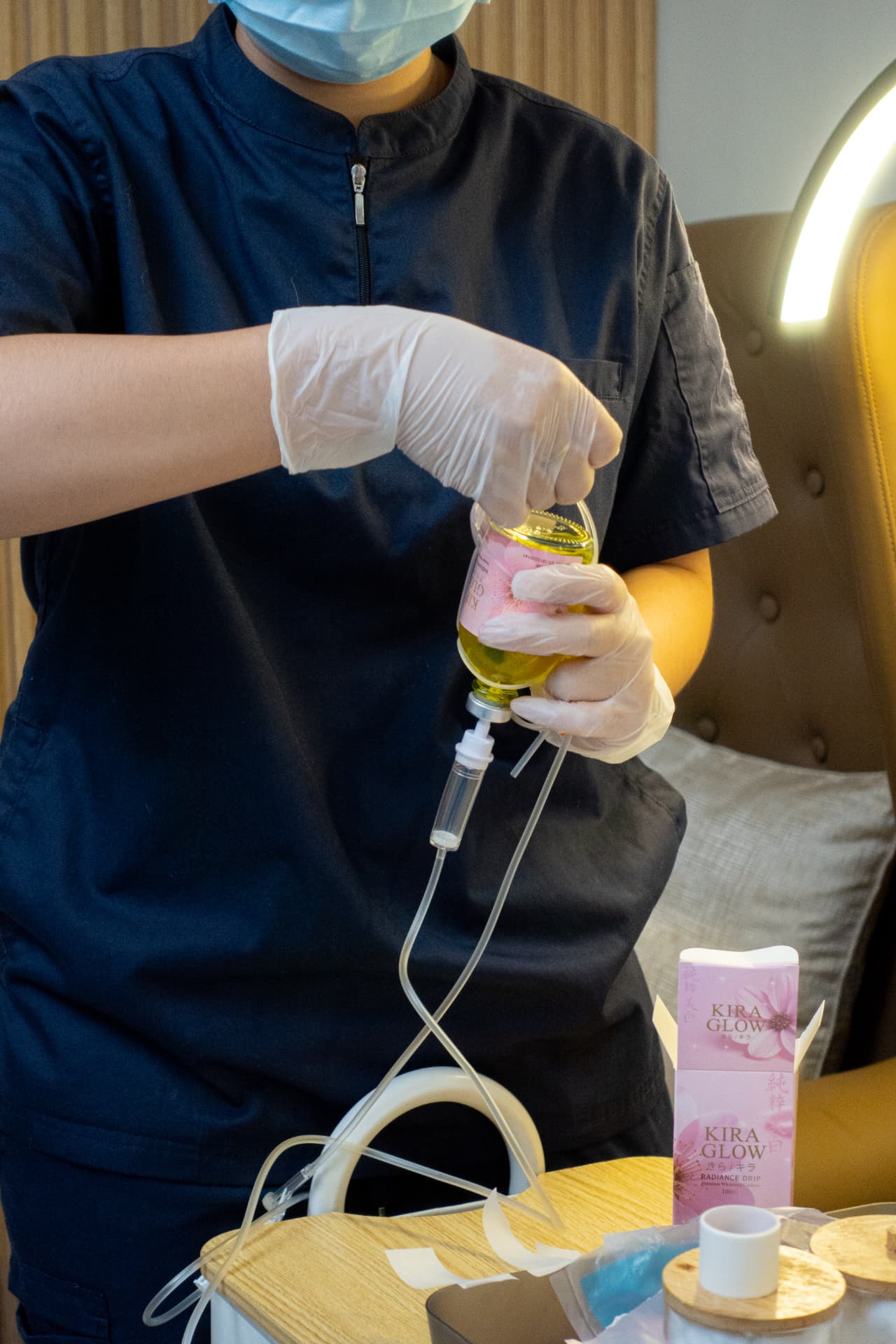Kira Glow Radiance Drip bottle being connected to the IV set